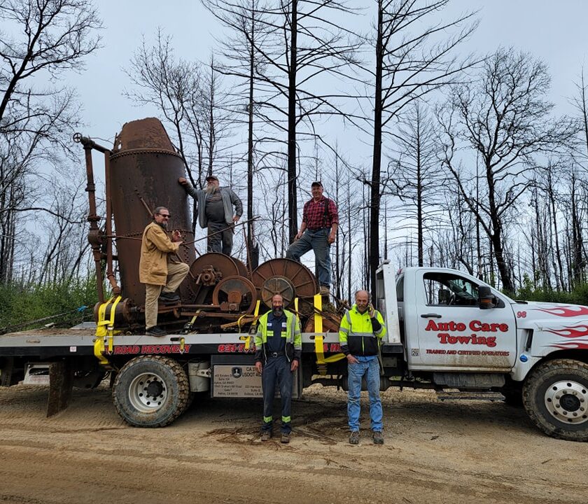 The moving team poses with the historic steam donkey logging industry artifact on China Grade after pulling it from deep in the Santa Cruz Mountains. Left to right: Charlie Brown, Steve Silva, Ross Mark, Bruce Baker, Kelvin Ramer.